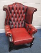 AN OXBLOOD LEATHER CHESTERFIELD WING BACK ARMCHAIR, raised on cabriole legs, width 85cm x depth 90cm