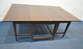 IN THE MANNER OF JAMES SHOOLBRED, AN EDWARDIAN MAHOGANY AND CROSSBANDED GATE LEG TABLE, raised on