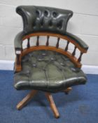 A REPRODUCTION GREEN BUTTONED LEATHER BOW TOP SWIVEL CAPTAINS CHAIR, raised on five legs with