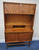 A TALL MID-CENTURY TEAK DESK / WALL CABINET, with two sets of double sliding doors, four drawers and