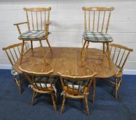 A DINETTE EXTENDING DINING TABLE, with a single fold out leaf, raised on turned legs, extended