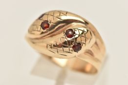 A 9CT GOLD DOUBLE SNAKE RING, two snakes entwined, set with circular cut garnets to the eyes,