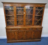 A REPRODUCTION YEW WOOD WALL UNIT, fitted with four glazed doors, atop a base with three drawers