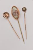 THREE STICK PINS, to include a rose metal Etruscan style pin unmarked, a yellow metal pin set with