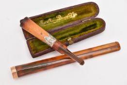 TWO CHEROOTS, a long cheroot with a yellow metal rim, unmarked, a cased cheroot with silver
