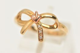 A BOXED 9CT GOLD 'CLOGAU' RING, yellow and rose gold detailed bow ring, set with single cut