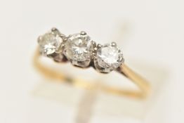 A YELLOW METAL THREE STONE DIAMOND RING, set with three round brilliant cut diamonds, each claw