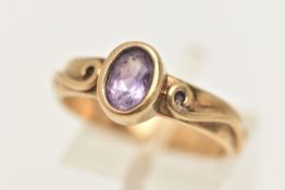 A BOXED 9CT GOLD 'CLOGAU' RING, set with an oval cut amethyst, collet set with a scrolling pattern