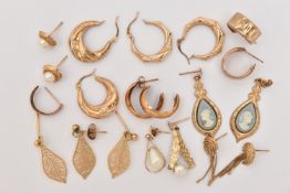 AN ASSORTMENT OF YELLOW METAL EARRINGS, to include two pairs of yellow metal creole hoops (one