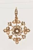 A YELLOW METAL SPLIT PEARL SET PENDANT/BROOCH, floral design set with a small seed pearl centre