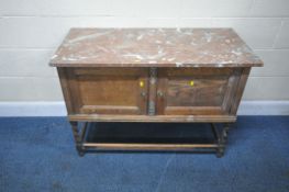 AN EARLY 20TH CENTURY OAK MARBLE TOP WASH STAND, with double cupboard doors, raised on barley