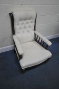 A VICTORIAN MAHOGANY FRAMED DEEP SEATED ARMCHAIR, with a scrolled button back, the armrests on