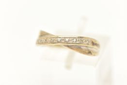 A 9CT WHITE GOLD DIAMOND SET CROSS OVER RING, set with a row of small single cut diamonds,