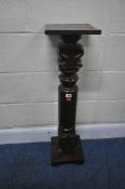 AN EARLY 20TH CENTURY MAHOGANY PLANT STAND, with foliate designs to the top and bottom of the