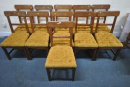 A SET OF ELEVEN OAK DINING CHAIRS, with mustard yellow buttoned upholstered seats, width 47cm x