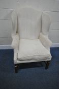 A GEORGIAN STYLE WINGBACK ARMCHAIR, with beige upholstery, width 80cm x depth 79cm x height 112cm,