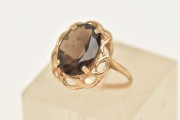 A 9CT GOLD GEM SET RING, an oval cut smoky quartz, prong set in yellow gold, open work mount,
