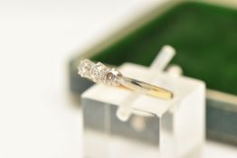 A THREE STONE DIAMOND RING, three transitional cut diamonds, prong set in white metal, leading on to