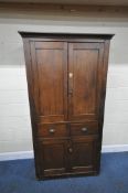 A STAINED PINE HOUSEKEEPERS CUPBOARD, fitted with four cupboard doors, and two drawers, width