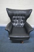 POSSIBLY A G PLAN BLOFELD MID-CENTURY BLACK LEATHERETTE BUTTONED WING BACK BOUNCING ARMCHAIR, raised
