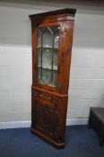 A GEORGIAN CORNER CUPBOARD, with a single glazed door, a single drawer and two dummy drawers, over a
