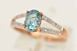 A 9CT GOLD BLUE ZIRCON AND DIAMOND RING, set with an oval cut blue zircon, four claw set between