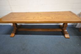 A LARGE SOLID OAK PLANK TOP RECTANGULAR DINING TABLE, raised on bulbous supports, shaped legs,