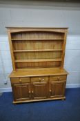 A MODERN PINE DRESSER, the three tier plate rack atop a base with three drawers over three