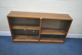 A MID-CENTURY TEAK BOOKCASE, with two sets of double glass sliding doors, width 137cm x depth 29cm x