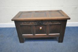 A GEORGIAN OAK COFFER, the hinged lid enclosing a candle box, the front with repeating lunette