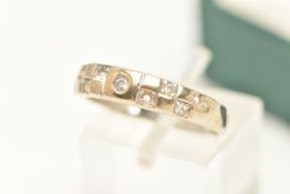 A WHITE METAL GEM SET RING, set with colourless cubic zirconia (two stones are missing and will