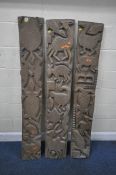 THREE CARVED WOODEN RECTANGULAR AFRICAN TRIBAL PANELS, depicting various animals and weapons, length