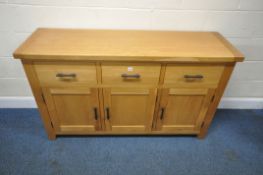 A MODERN LIGHT OAK SIDEBOARD, fitted with three drawers over triple cupboard doors, length 151cm x