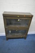 SANKEY SHELDON, AN ARMY GREEN METAL GLOBE WERNICKE STYLE ELASTIC BOOKCASE, with two glass hide and