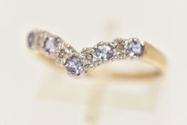 A 9CT GOLD GEM SET RING, designed as a wishbone ring, prong set with five circular cut tanzanite'