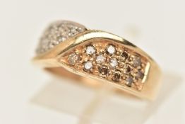 A 9CT GOLD GEM SET RING, designed as a yellow gold cross over ring, pave set with colourless and