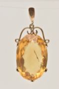 A YELLOW METAL CITRINE SET PENDANT, set with a large oval cut Citrine measuring approximately length