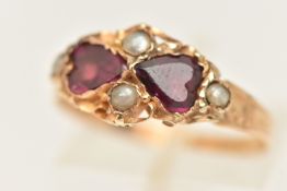 AN EARLY 20TH CENTURY 15CT GOLD RING, two flat heart cut tourmalines, accented with four seed