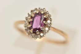A 9CT GOLD GEM SET CLUSTER RING, designed as a principally set oval cut ruby, prong set with a