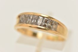 YELLOW METAL GEM SET RING, a yellow metal ring, channel set with rectangular cut cubic zirconia,
