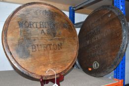 TWO WOODEN BEER BARREL LIDS, one stamped 'WORTHINGTON, AE, BURTON' and numbered '67', the other '