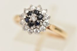 A 9CT GOLD GEM SET CLUSTER RING, a principally set circular cut cubic zirconia, prong set with a