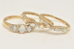 A SET OF THREE 9CT GOLD GEM SET RINGS, yellow gold three ring set designed as a three stone opal