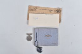 A WWII MEDAL WITH DISCHARGE LETTER AND A SMALL PHOTO ALBUM, the medal is 1939-45 award missing its