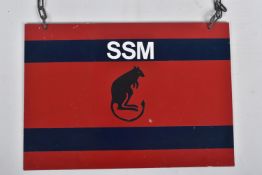 A METAL PRINTED SIGN, crimson red with navy blue bands, marked in white SSM and featuring a black