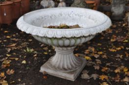 A WHITE PAINTED CAST IRON CAMPAGNA URN, of a low wide form, on a square base, diameter 75cm x height