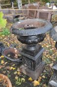 AN EARLY 20th CENTURY CAST IRON CAMPAGNA GARDEN URN ON STAND with balustered bowl and foliate detail