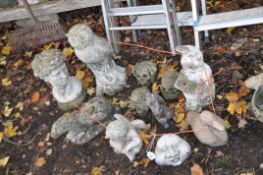 A SELECTION OF CONCRETE GARDEN ORNAMENTS, to include three hear speak see no evil skulls, gnome,