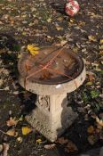 A WEATHERED CONCRETE BIRD BATH, on a square tapered plinth, diameter 39cm x height 50cm, condition