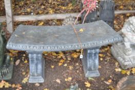 A PAINTED CONCRETE CURVED BENCH, on a of scrolled supports, length 122cm x depth 40cm x height 46cm,